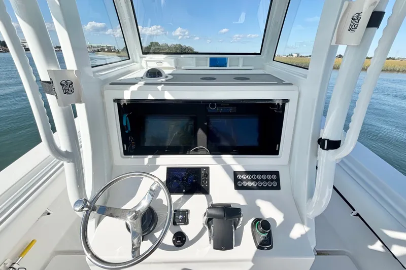 Slide: The Image of 2026 Onslow Bay 33 Tournament Edition boat helm with modern controls and navigation system. - 10
