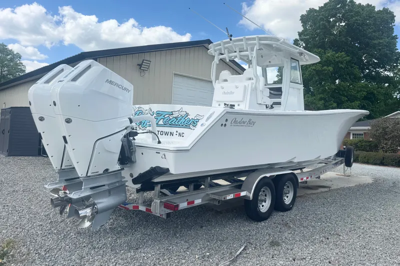 Slide: The Image of 2026 Onslow Bay 33 Tournament Edition boat on trailer, featuring dual Mercury engines. - 8