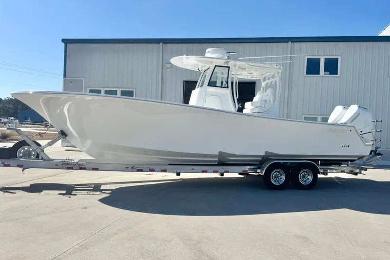 Slide: The Image of 2026 Onslow Bay 33 Tournament Edition boat on trailer, parked outside a building. - 4