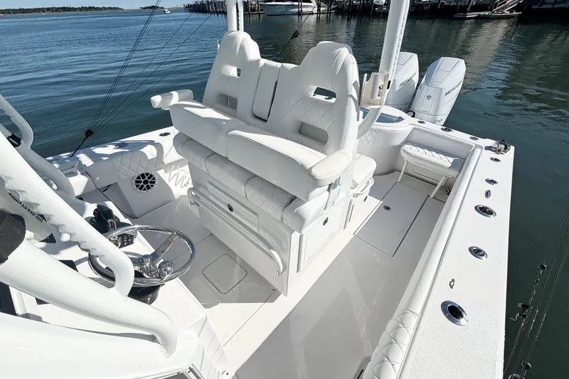 Slide: The Image of 2026 Onslow Bay 33 Tournament Edition boat interior with white seating and dual engines. - 14