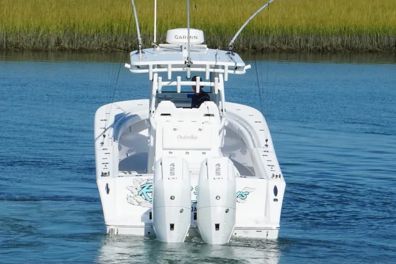 Slide: The Image of 2026 Onslow Bay 33 Tournament Edition boat on calm water, rear view. - 6