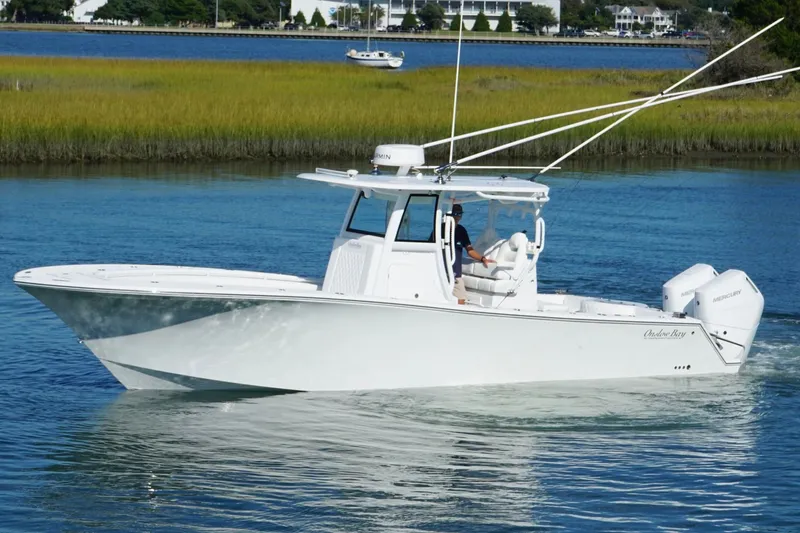 Slide: The Image of 2026 Onslow Bay 33 Tournament Edition boat cruising on a serene waterway. - 5