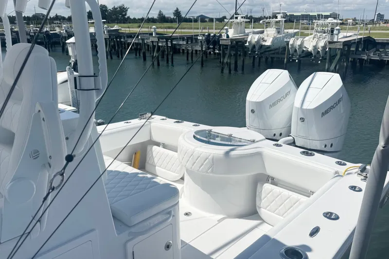Slide: The Image of 2026 Onslow Bay 33 Tournament Edition boat with dual Mercury engines docked at marina. - 16