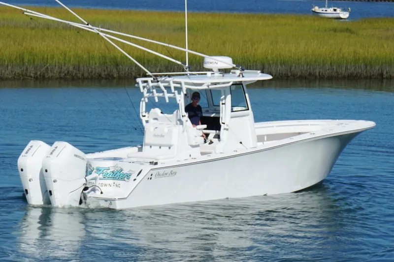Slide: The Image of 2026 Onslow Bay 33 Tournament Edition boat cruising on calm water. - 7