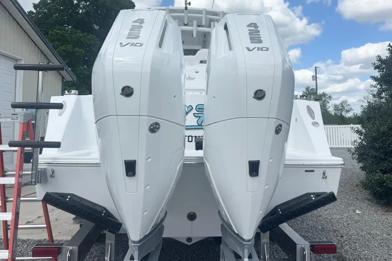 Slide: The Image of 2026 Onslow Bay 33 Tournament Edition with dual 425 V10 engines, parked outdoors. - 9