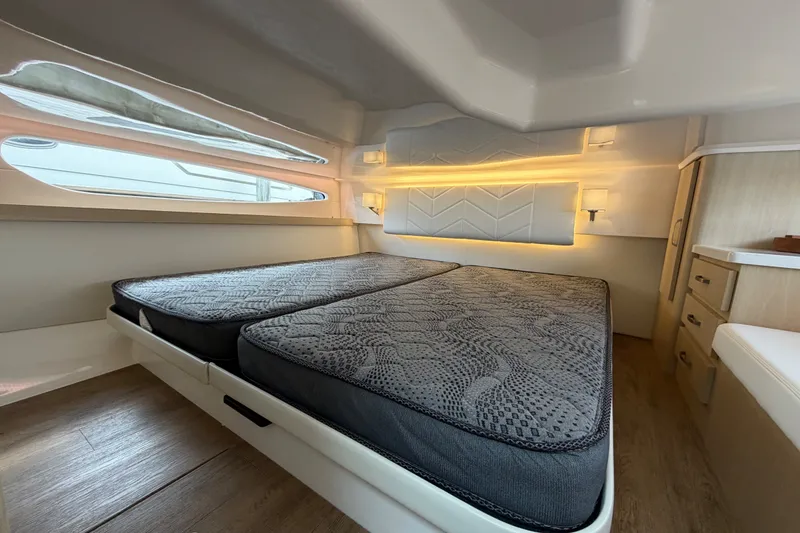 Slide: The Image of Luxurious interior cabin of 2023 Regal 38 XO yacht with twin beds and modern lighting. - 24