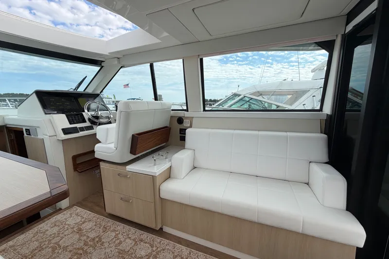 Slide: The Image of Interior of 2023 Regal 38 XO yacht with white seating and modern helm. - 12