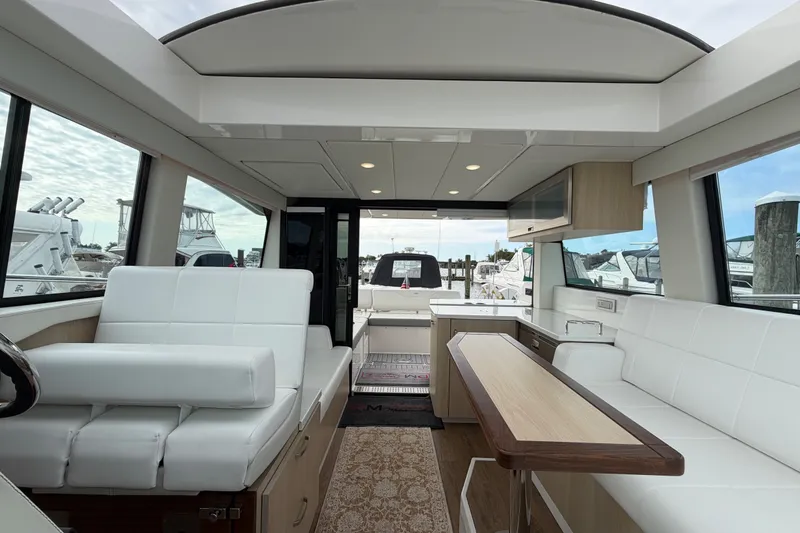 Slide: The Image of Luxurious interior of 2023 Regal 38 XO yacht with white seating and modern design. - 18