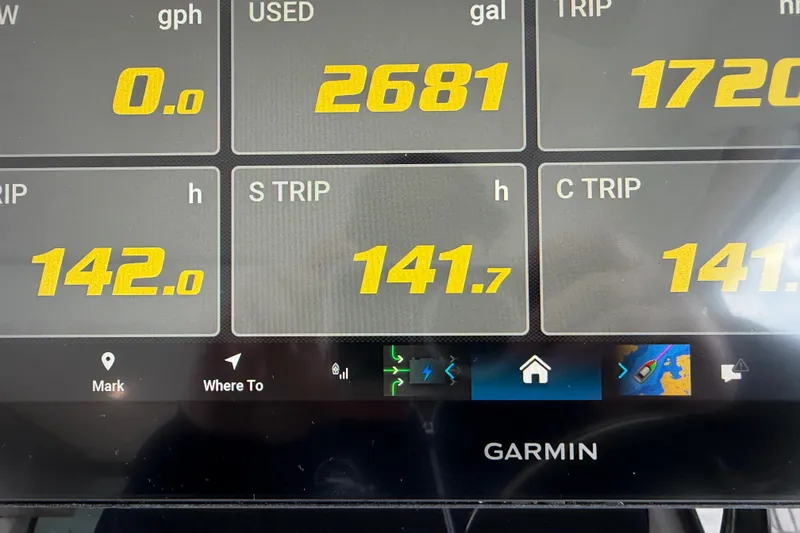 Slide: The Image of Garmin display showing fuel and trip data for 2023 Regal 38 XO boat. - 38