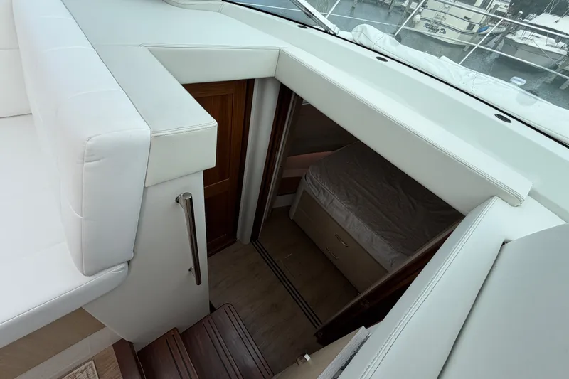 Slide: The Image of Interior view of 2023 Regal 38 XO yacht cabin with stairs and bed. - 19