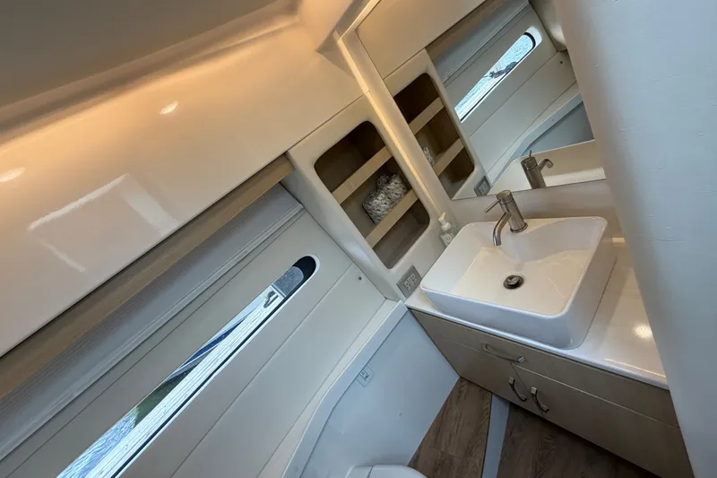 Slide: The Image of Modern bathroom interior of 2023 Regal 38 XO yacht with sleek sink and mirror. - 28