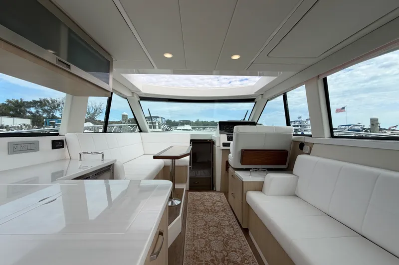 Slide: The Image of Luxurious interior of 2023 Regal 38 XO yacht with modern seating and panoramic windows. - 9