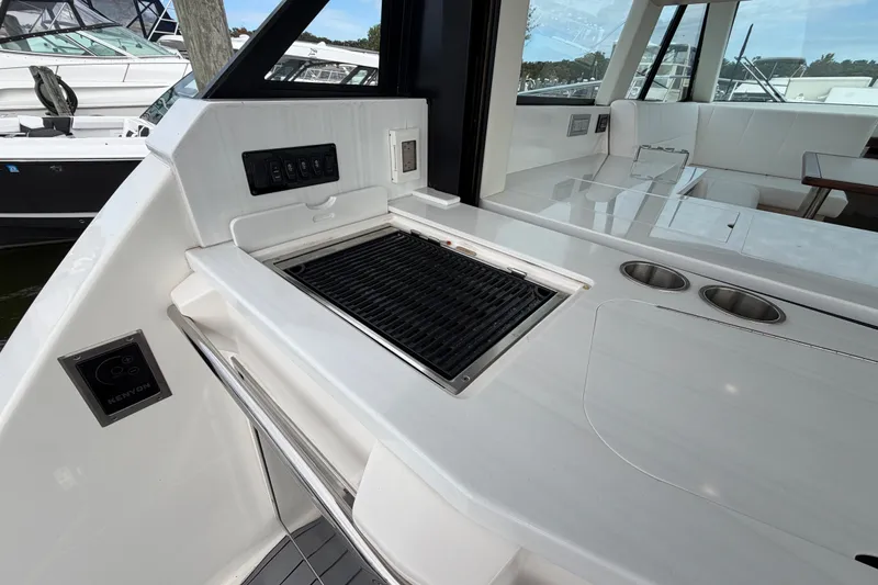 Slide: The Image of Outdoor kitchen area on 2023 Regal 38 XO yacht with grill and seating. - 8