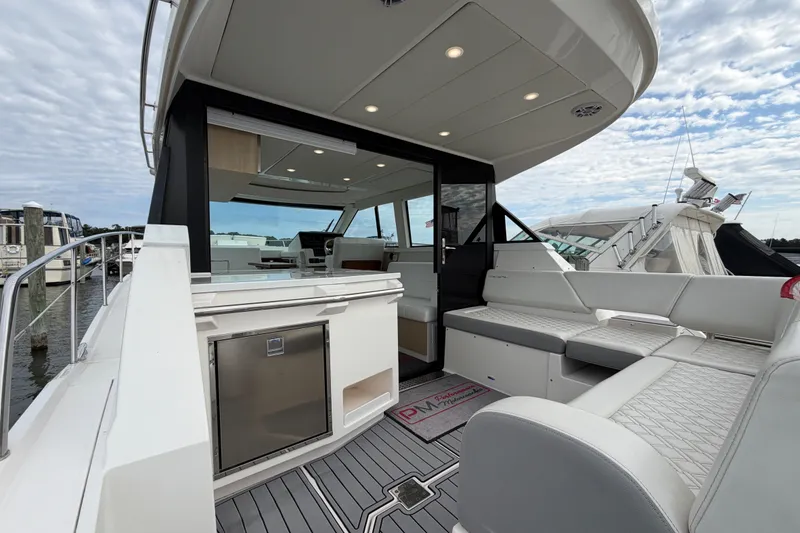 Slide: The Image of 2023 Regal 38 XO yacht with sleek interior and spacious seating area. - 5