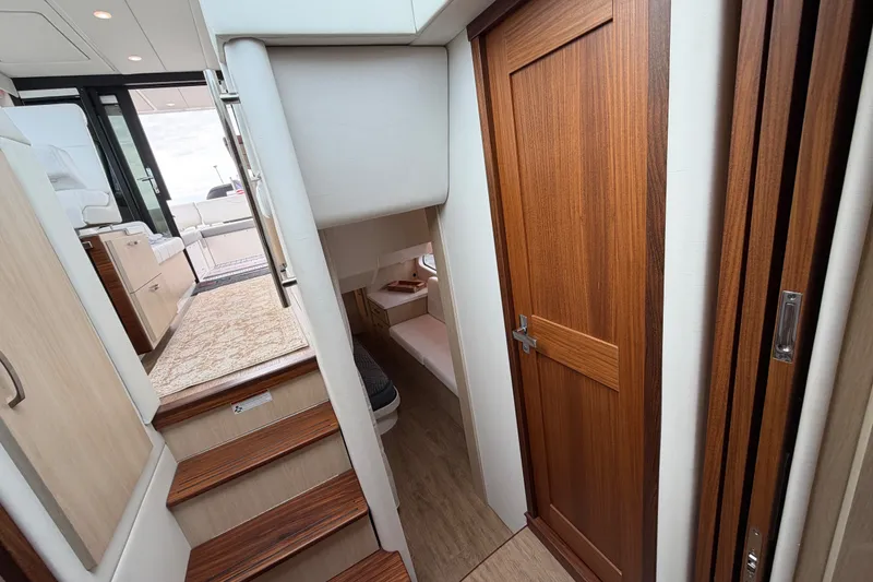 Slide: The Image of 2023 Regal 38 XO yacht interior with wooden door and stairs. - 23