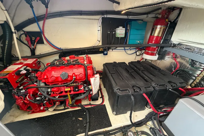 Slide: The Image of Engine room of 2023 Regal 38 XO yacht with red engine and battery setup. - 33