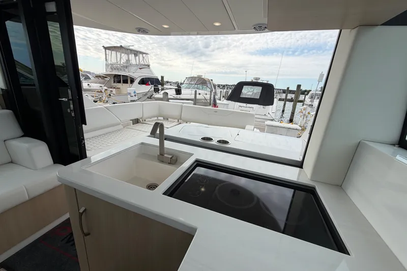 Slide: The Image of Luxurious interior of 2023 Regal 38 XO yacht with modern kitchenette and marina view. - 10