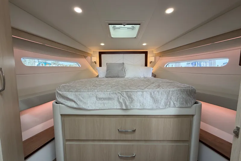 Slide: The Image of Luxurious 2023 Regal 38 XO yacht cabin with elegant bedding and modern lighting. - 20
