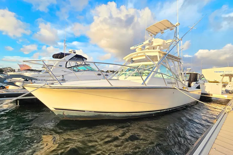 The Image of 2007 Carolina Classic 28 Express boat docked under a vibrant sky. - 1