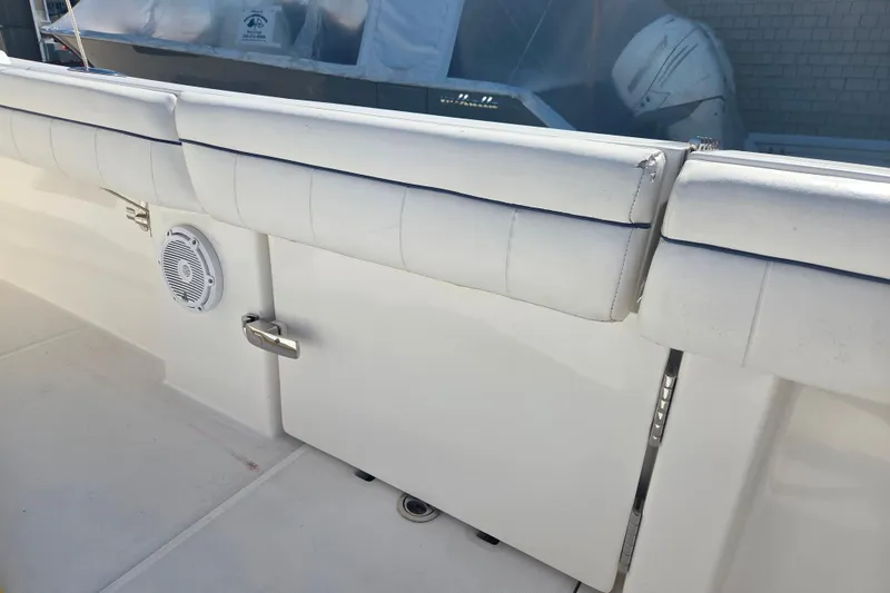 Slide: The Image of 2016 Regulator 41 boat interior with white cushioned seating and speaker. - 18