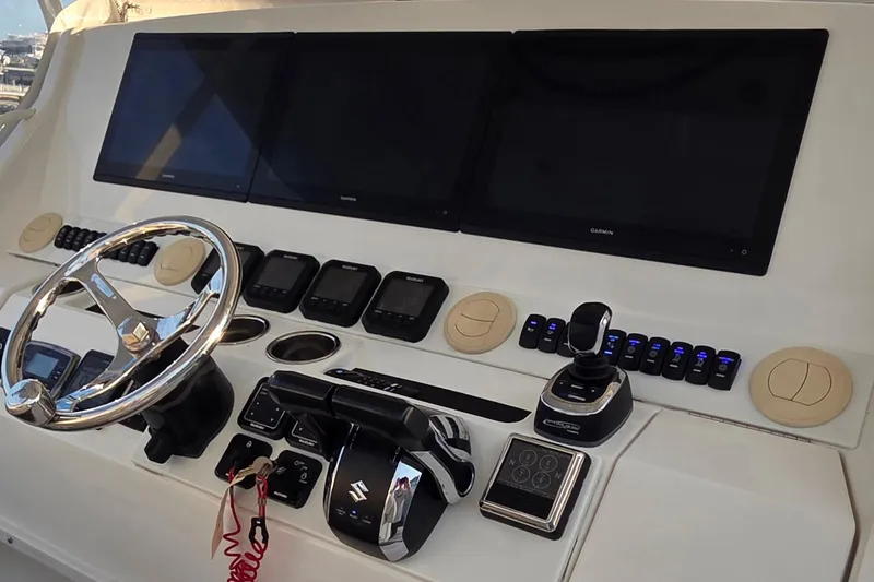 Slide: The Image of Control panel of a 2016 Regulator 41 boat with steering wheel and navigation screens. - 10