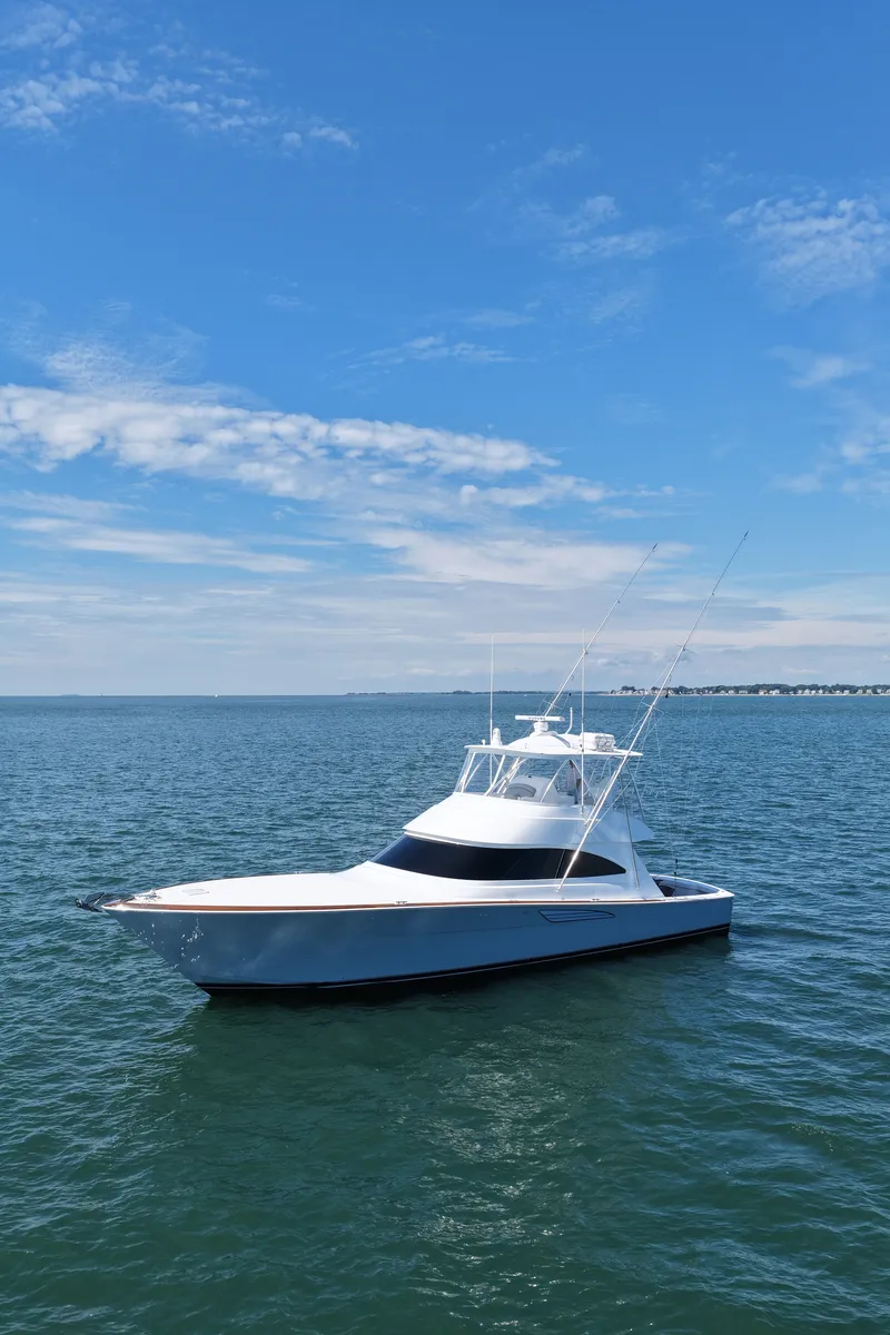 Slide: The Image of A sleek, modern boat on calm waters under a blue sky. - 2