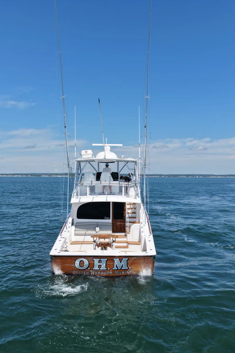 Slide: The Image of A sleek, modern boat on open water with multiple fishing rods and a spacious deck. - 8