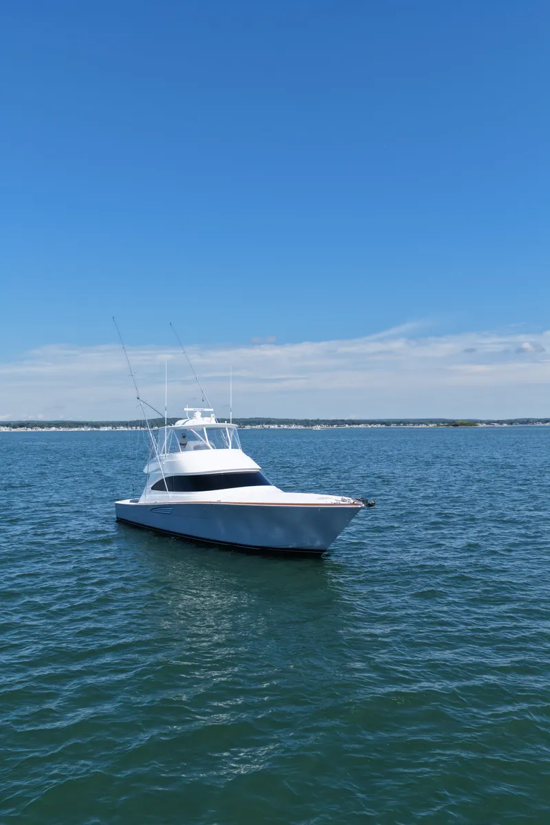 Slide: The Image of A sleek, modern boat on calm waters under a clear sky. - 6