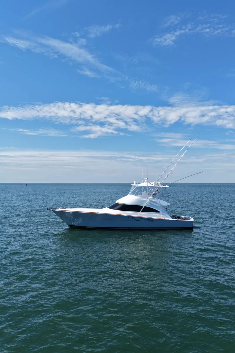 Slide: The Image of A sleek, modern boat on calm waters under a blue sky. - 3