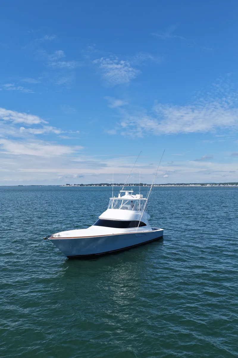 Slide: The Image of A sleek, modern boat on calm waters under a blue sky. - 4