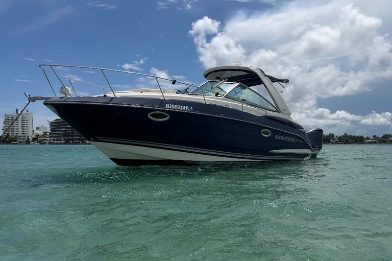 The Image of 2018 Monterey 280 Sport Yacht on clear turquoise water under a partly cloudy sky. - 0