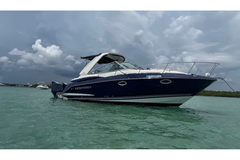 Slide: The Image of 2014 Monterey 280 Sport Yacht on calm waters under cloudy skies. - 13