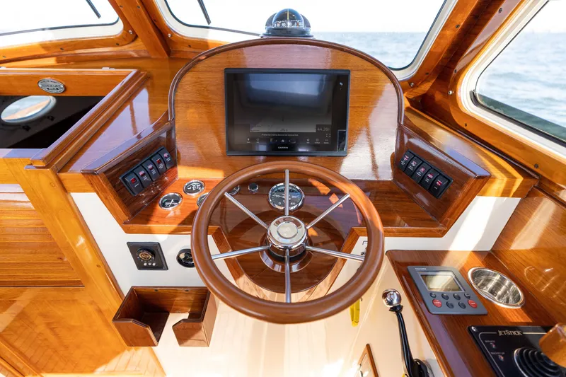 Slide: The Image of Helm of 2006 Hinckley Picnic Boat 36 EP with wooden finish and modern controls. - 37