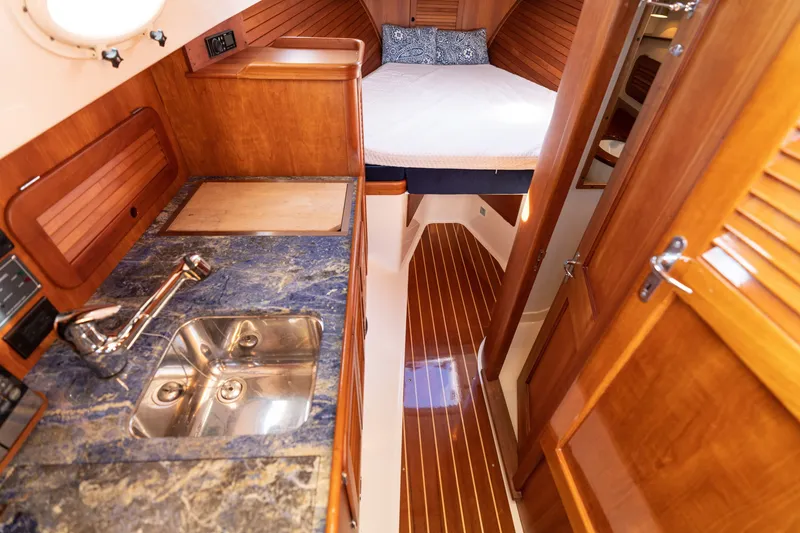 Slide: The Image of Interior of 2006 Hinckley Picnic Boat 36 EP with wood finish and compact kitchen. - 39