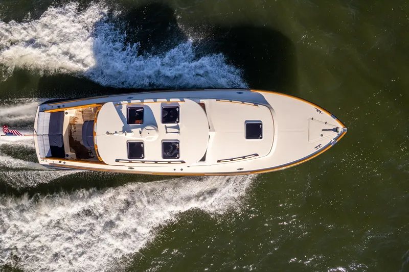 Slide: The Image of Top view of a 2006 Hinckley Picnic Boat 36 EP cruising on water. - 13