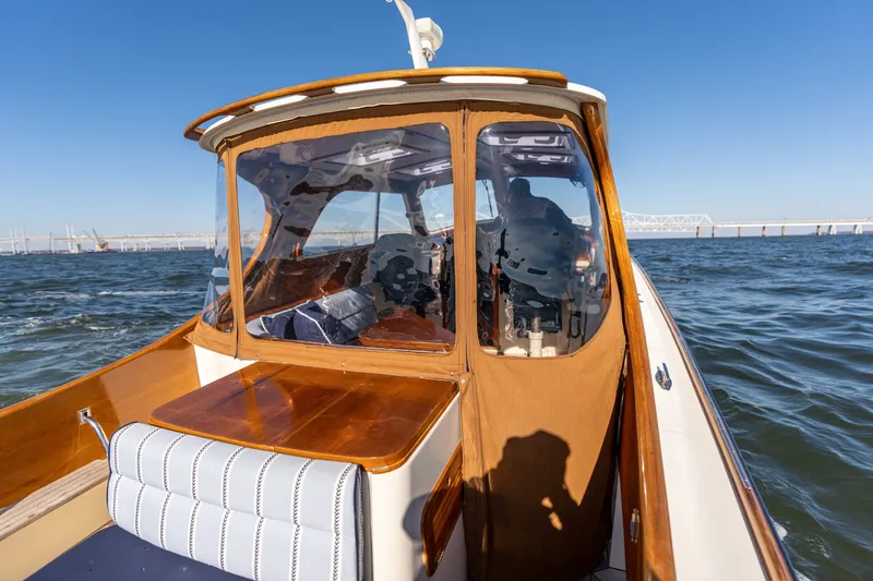 Slide: The Image of 2006 Hinckley Picnic Boat 36 EP cruising on open water under clear blue skies. - 23