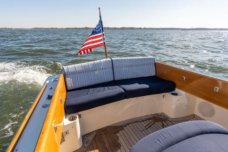 Slide: The Image of 2006 Hinckley Picnic Boat 36 EP with American flag, featuring elegant seating on open water. - 20