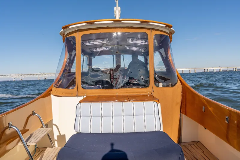 Slide: The Image of 2006 Hinckley Picnic Boat 36 EP cruising on open water with bridge in background. - 22