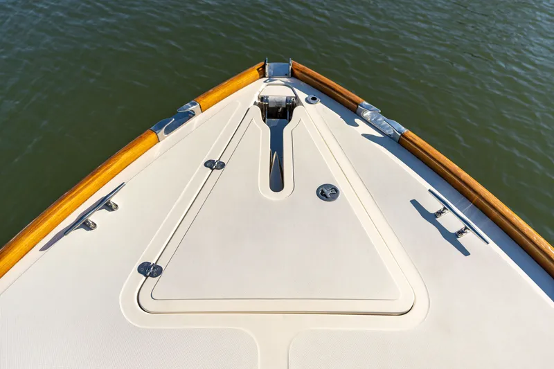 Slide: The Image of Bow of 2006 Hinckley Picnic Boat 36 EP with teak accents on calm water. - 15
