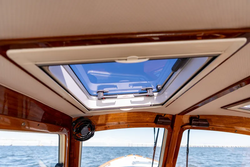 Slide: The Image of 2006 Hinckley Picnic Boat 36 EP interior with open skylight, showcasing ocean view. - 32