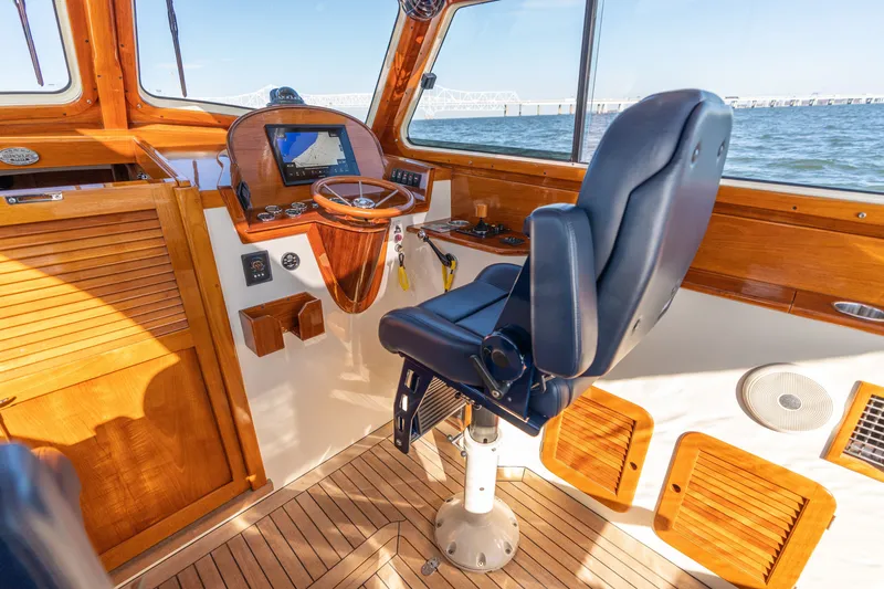 Slide: The Image of Interior of 2006 Hinckley Picnic Boat 36 EP with helm, wooden accents, and ocean view. - 36