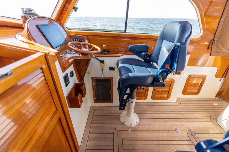 Slide: The Image of Helm of 2006 Hinckley Picnic Boat 36 EP with wooden dashboard and leather captain's chair. - 35