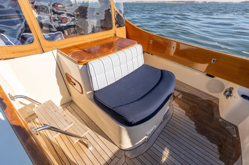 Slide: The Image of 2006 Hinckley Picnic Boat 36 EP interior with elegant seating and wooden accents on the water. - 21