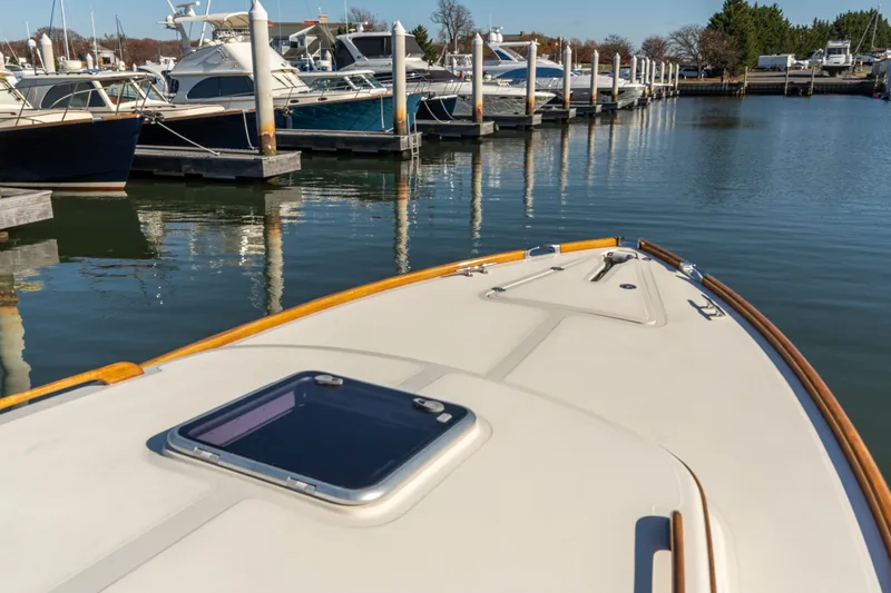 Slide: The Image of Hinckley Picnic Boat 36 EP, 2006 model, docked in a marina with other boats. - 14