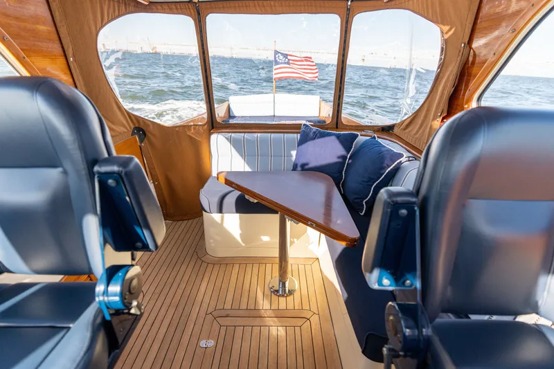 Slide: The Image of Interior of 2006 Hinckley Picnic Boat 36 EP with seating and American flag. - 27