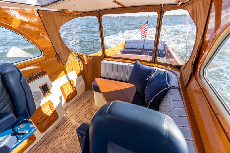 Slide: The Image of Interior of 2006 Hinckley Picnic Boat 36 EP with elegant seating and wooden finishes. - 26