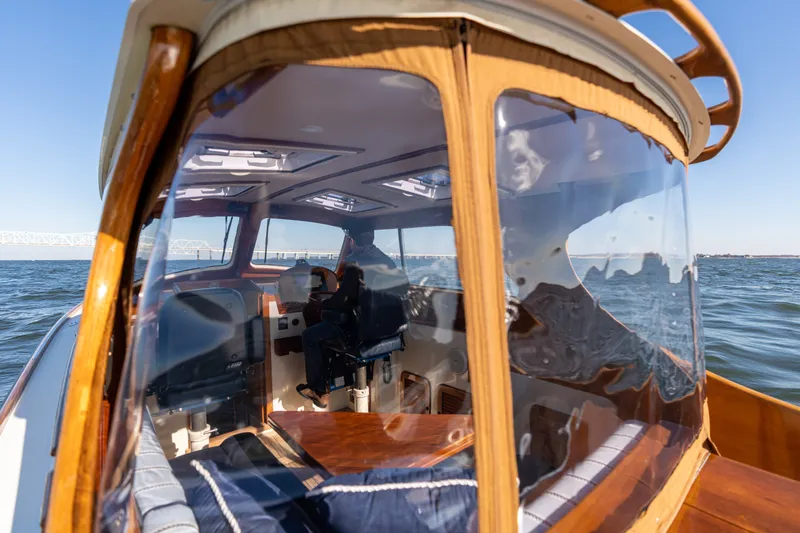 Slide: The Image of 2006 Hinckley Picnic Boat 36 EP cruising on open water, showcasing elegant interior design. - 24
