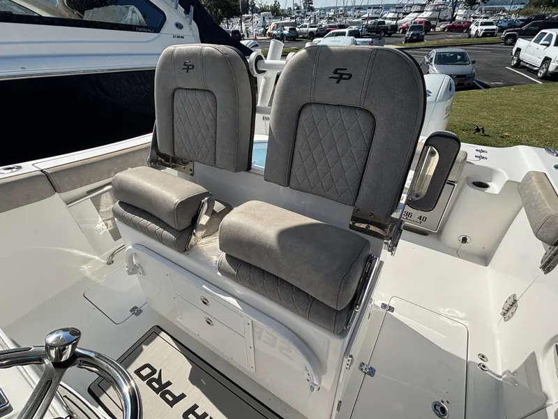 Slide: The Image of Two cushioned seats on a boat with gray fabric and quilted pattern. - 7