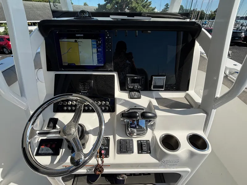 Slide: The Image of The image shows the helm of a 2021 Sea Pro 259 DLX boat with modern instruments. - 6