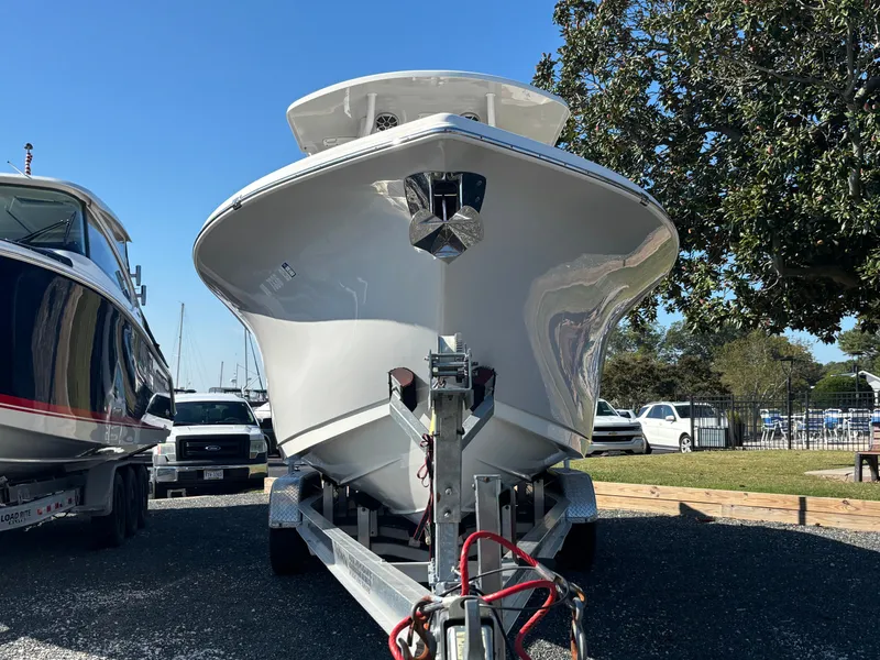 Slide: The Image of A 2021 Sea Pro 259 DLX boat on a trailer, ready for transport. - 1